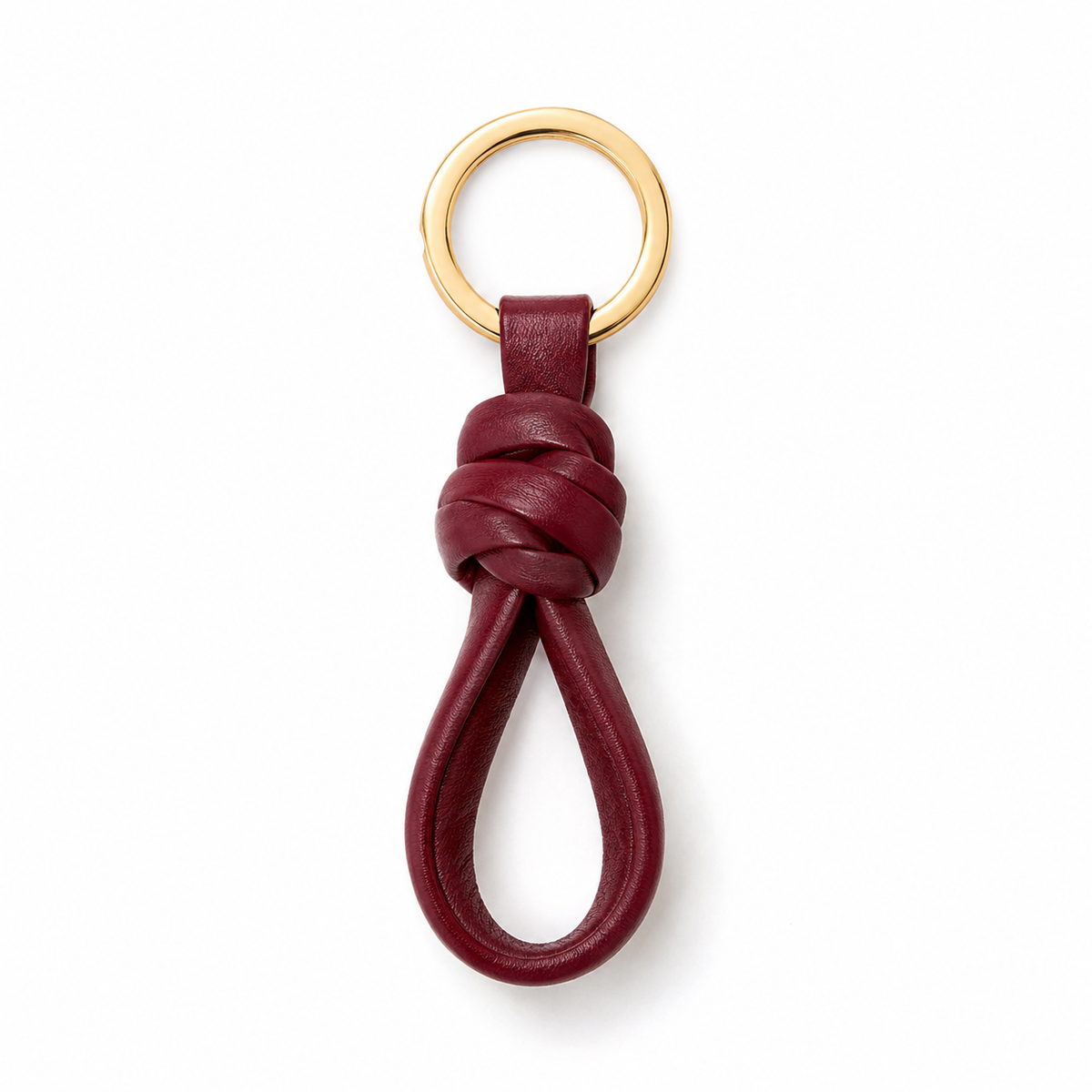 Portachiavi in pelle annodata colore bordeaux con anello dorato.