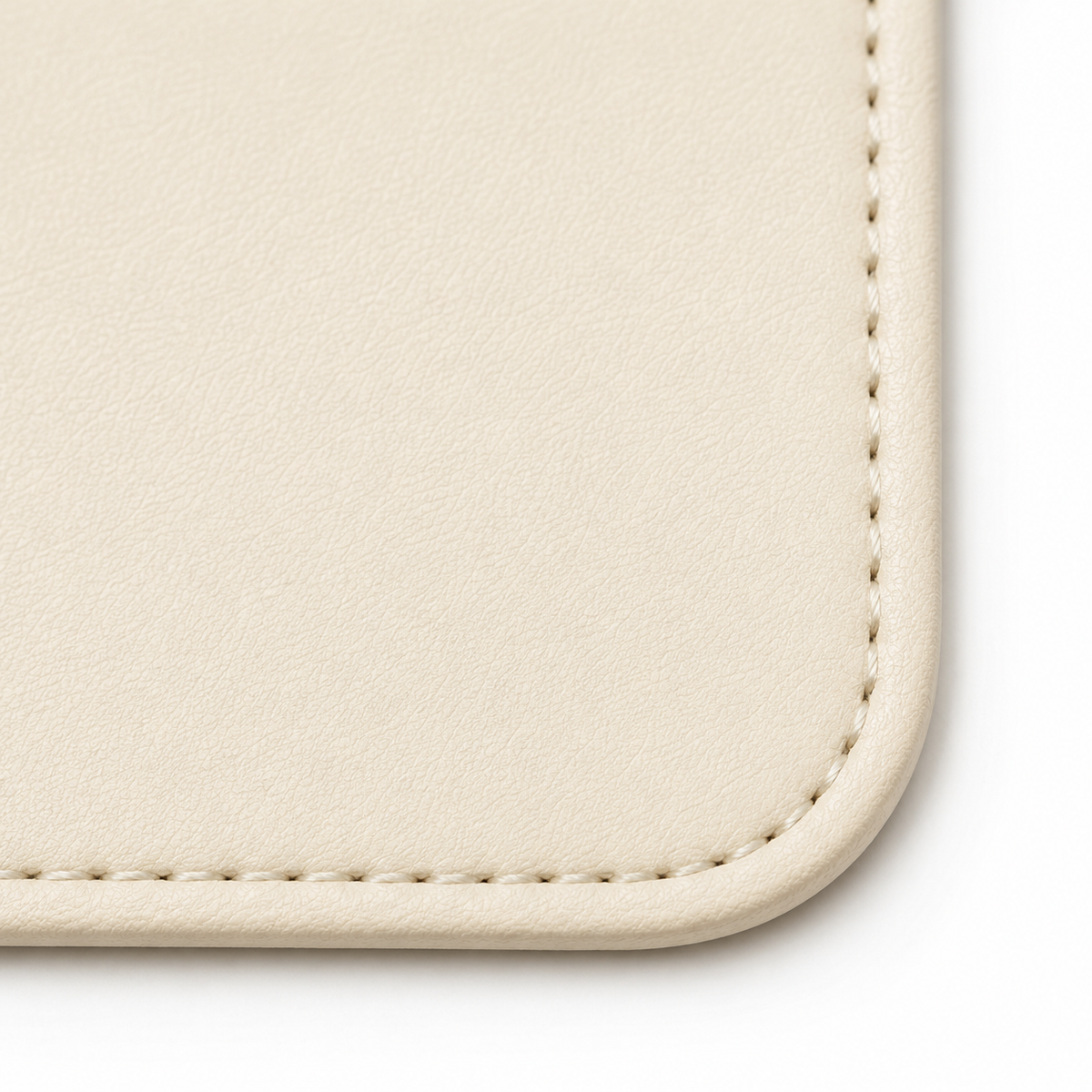 Angolo del tappetino da scrivania beige con cuciture